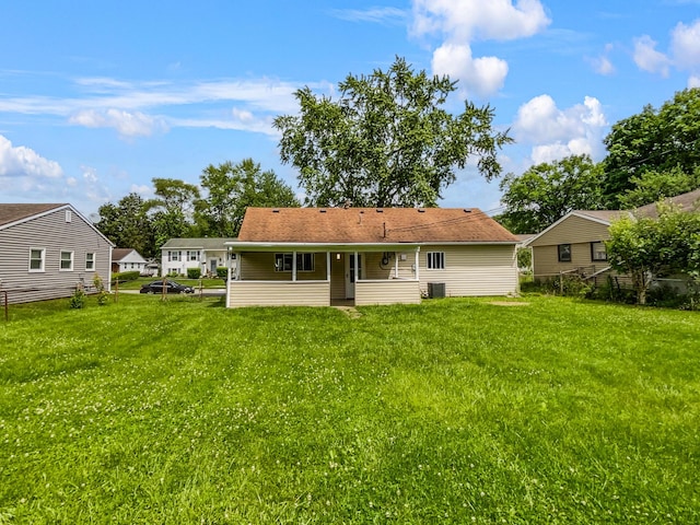 back of house with a yard