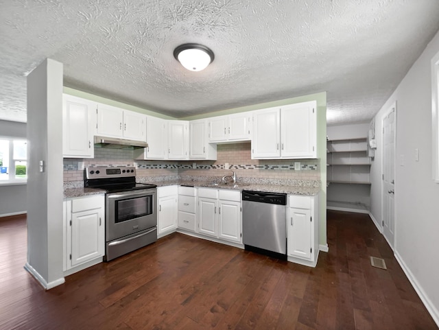 kitchen featuring dark hardwood / wood-style flooring, white cabinetry, extractor fan, and appliances with stainless steel finishes