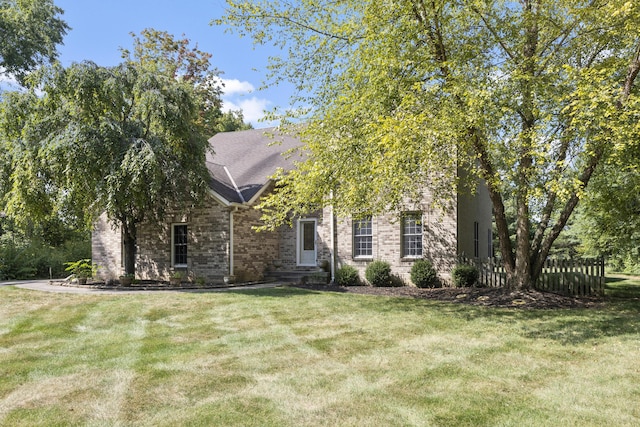 obstructed view of property featuring a front lawn