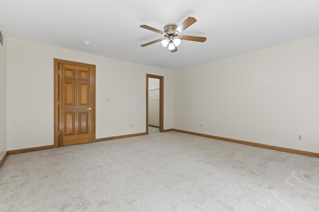 unfurnished room with light carpet and ceiling fan