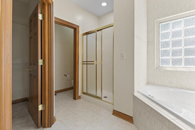 bathroom with separate shower and tub, a wealth of natural light, tile patterned floors, and toilet