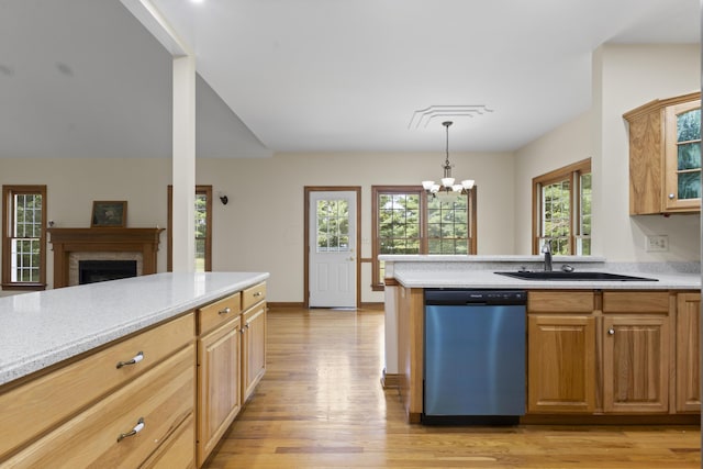 kitchen with stainless steel dishwasher, a healthy amount of sunlight, sink, and light hardwood / wood-style flooring