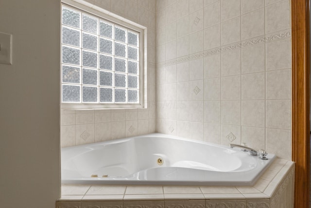 bathroom featuring a relaxing tiled tub and a wealth of natural light