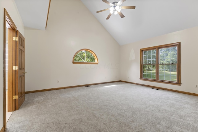 unfurnished room featuring light carpet, high vaulted ceiling, and ceiling fan