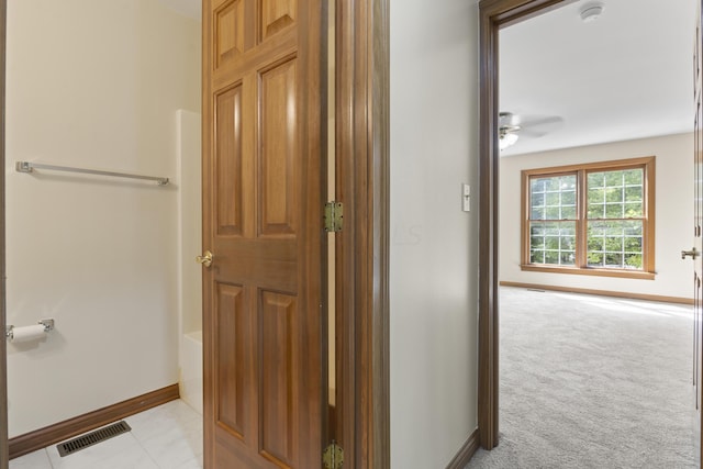 corridor with light colored carpet