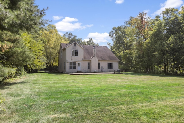 rear view of house with a yard