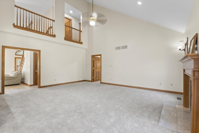 unfurnished living room featuring ceiling fan, high vaulted ceiling, and light colored carpet