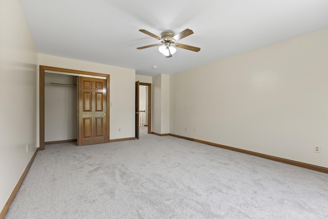 unfurnished bedroom with ceiling fan, light colored carpet, and a closet