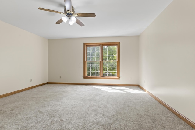 empty room with carpet and ceiling fan