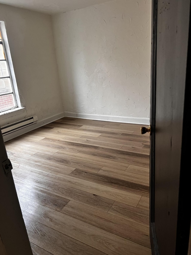 1001 Lilley Ave, Columbus, OH 43206 - unfurnished room featuring light wood-type flooring and a baseboard heating unit