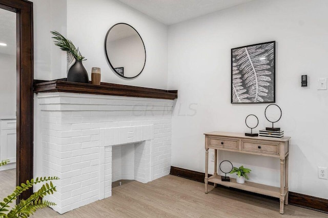 room details with hardwood / wood-style flooring and a brick fireplace