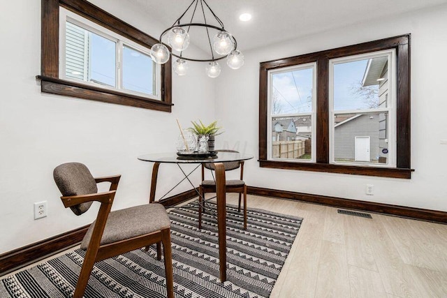 interior space featuring light hardwood / wood-style floors and an inviting chandelier