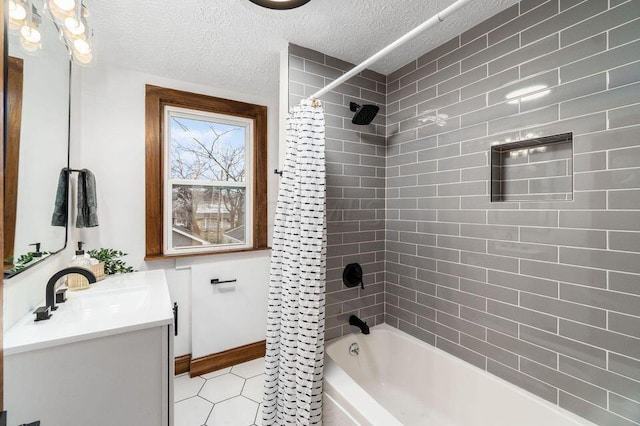 bathroom with vanity, shower / tub combo, and a textured ceiling