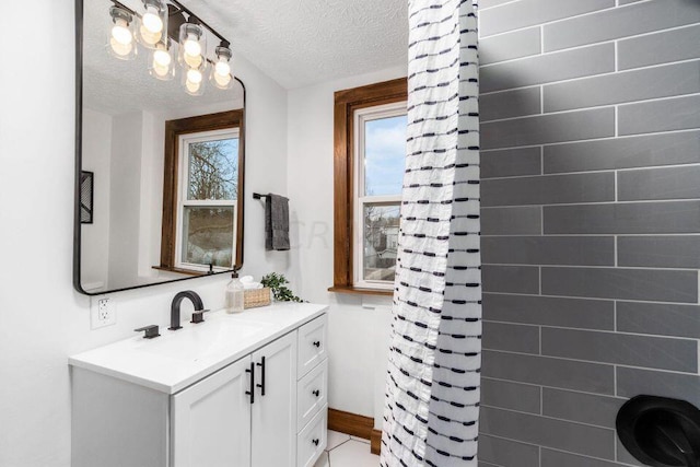 386 E Welch Ave, Columbus, OH 43207 - bathroom featuring vanity, a shower with curtain, and a textured ceiling