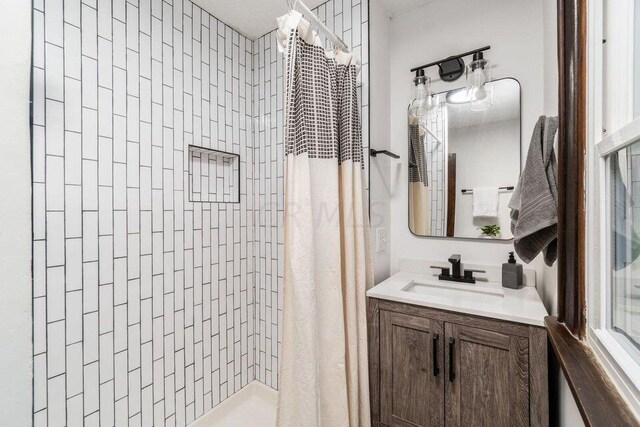 386 E Welch Ave, Columbus, OH 43207 - bathroom with a tile shower and vanity