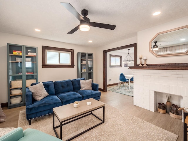 386 E Welch Ave, Columbus, OH 43207 - living area featuring a ceiling fan, wood finished floors, a textured ceiling, and recessed lighting