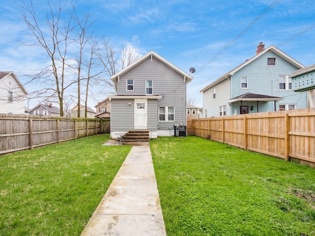 386 E Welch Ave, Columbus, OH 43207 - rear view of house with a fenced backyard and entry steps