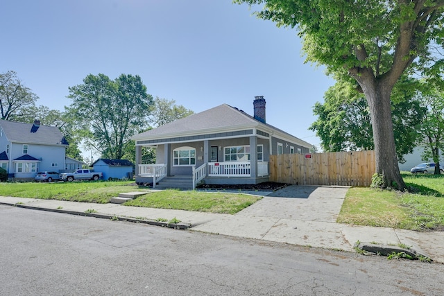 bungalow-style home with a porch and a front yard