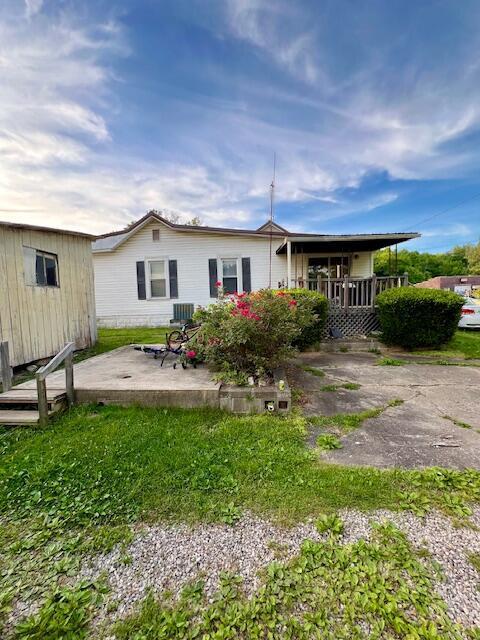 back of house featuring a wooden deck