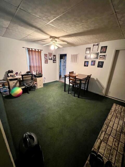 dining room featuring dark colored carpet and ceiling fan