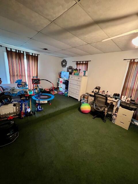 playroom featuring a paneled ceiling and carpet