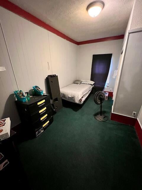 carpeted bedroom with a textured ceiling