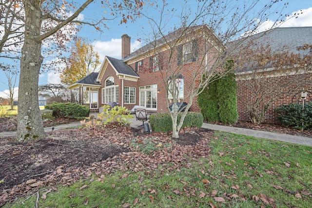 rear view of property with a yard