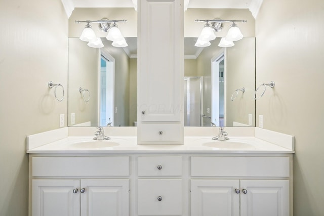 bathroom with a shower with door, vanity, and ornamental molding