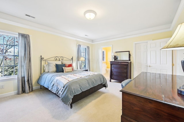 bedroom with carpet flooring, connected bathroom, and crown molding