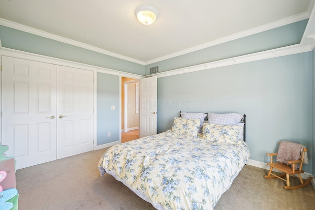 bedroom with carpet floors, a closet, and ornamental molding