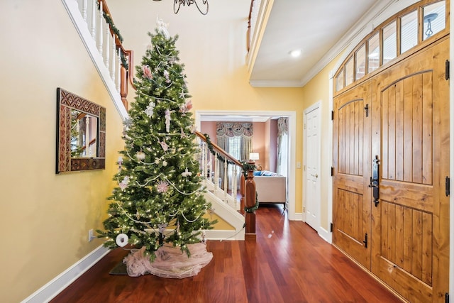 foyer with dark hardwood / wood-style floors and ornamental molding