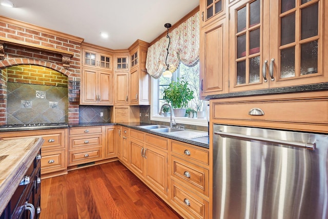 kitchen featuring appliances with stainless steel finishes, sink, decorative light fixtures, butcher block countertops, and dark hardwood / wood-style floors