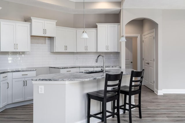 kitchen with tasteful backsplash and white cabinetry