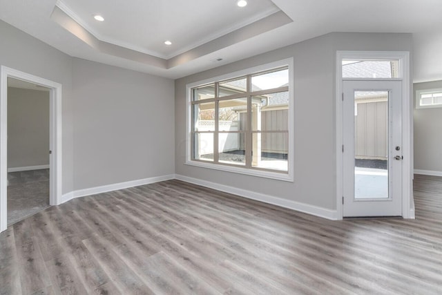 interior space featuring plenty of natural light, ornamental molding, and light hardwood / wood-style flooring