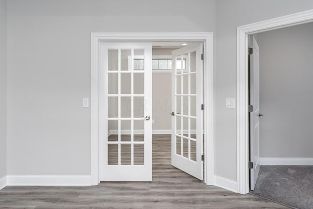 entryway with french doors and light hardwood / wood-style flooring