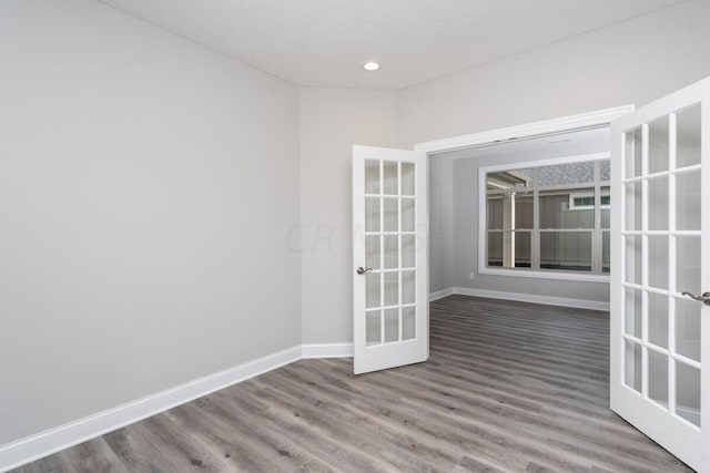 unfurnished room featuring french doors and hardwood / wood-style flooring