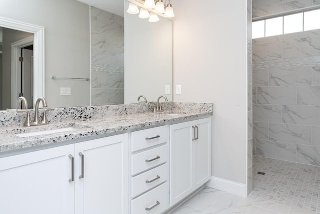 bathroom with vanity and a tile shower