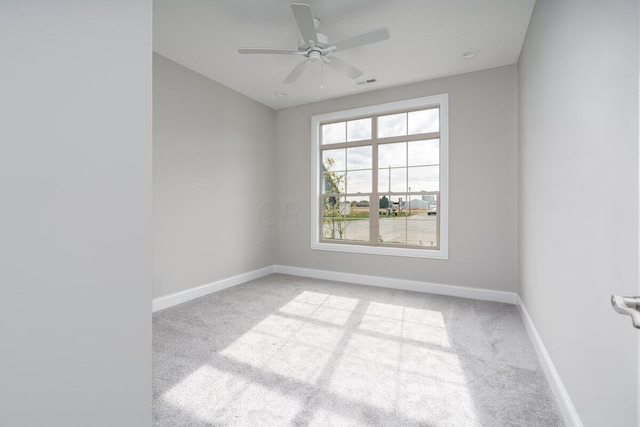 carpeted spare room featuring ceiling fan