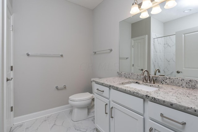 bathroom featuring vanity, toilet, and a shower