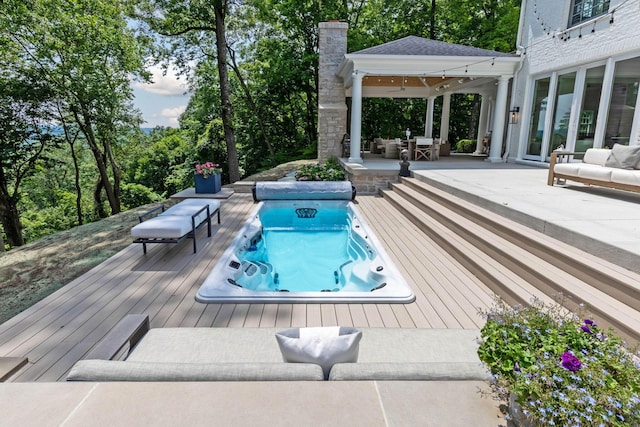 view of swimming pool with outdoor lounge area and a deck