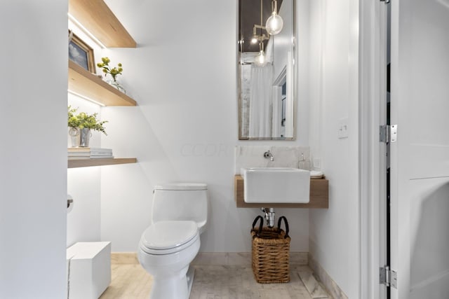 bathroom with wood-type flooring and toilet