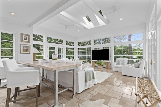 sunroom featuring beamed ceiling, french doors, and ceiling fan