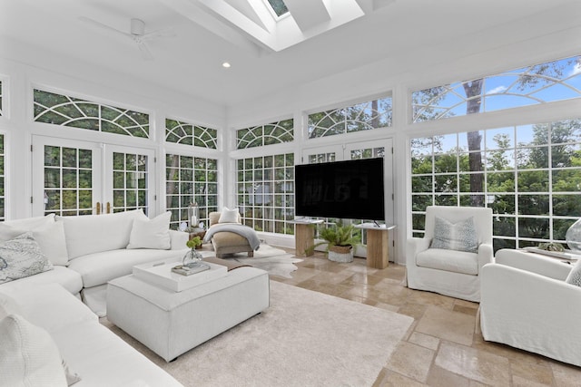 sunroom featuring ceiling fan and french doors