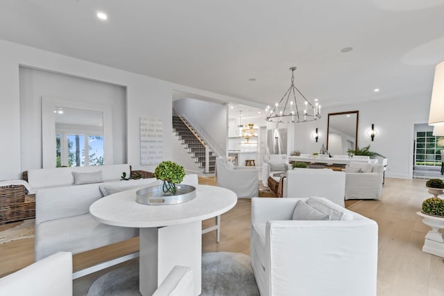 dining space with light hardwood / wood-style flooring and a notable chandelier