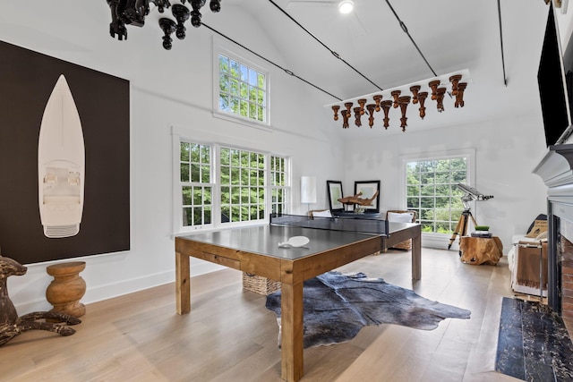 playroom with light hardwood / wood-style flooring and vaulted ceiling