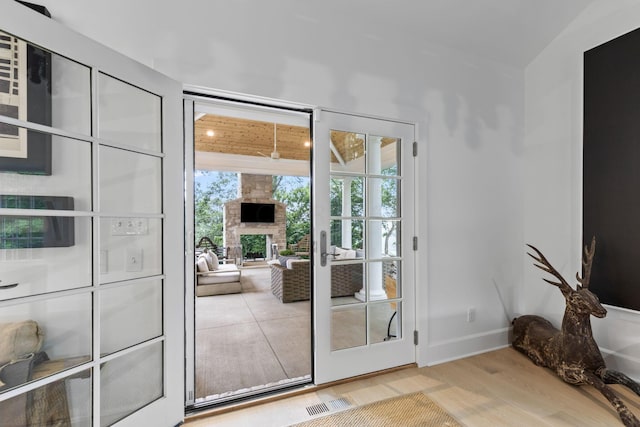 entryway with plenty of natural light, french doors, and hardwood / wood-style flooring