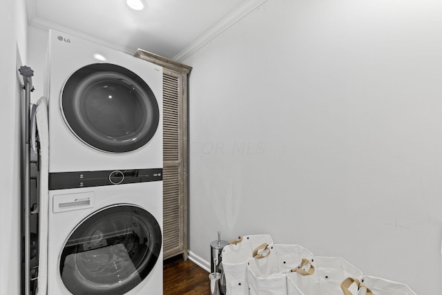 clothes washing area with stacked washer / drying machine, ornamental molding, and dark wood-type flooring