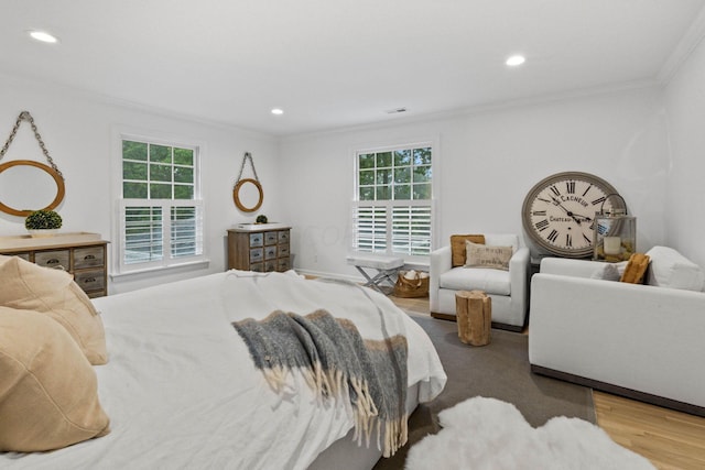 bedroom with wood-type flooring and ornamental molding