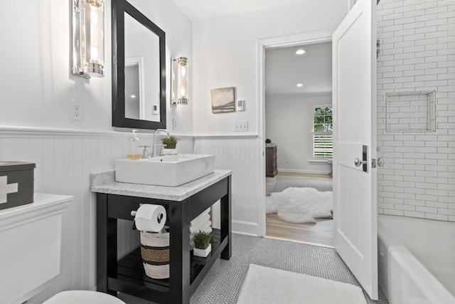 bathroom featuring a bathing tub, vanity, and tile patterned floors