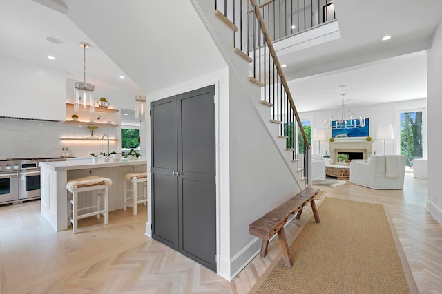 staircase featuring lofted ceiling and parquet flooring